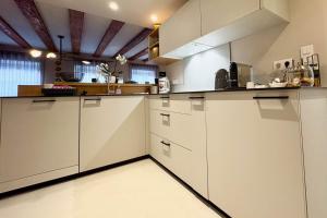a kitchen with white counters and white cabinets at Luxury apartment in the city center in Strasbourg