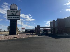 a sign for a car dealership in a parking lot at Candlelight Inn by Capital O Scottsbluff in Scottsbluff