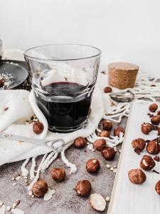 a cup of coffee sitting on a table with hazelnuts at LA SEGRETA DEL CASTELLO, Private Access in Gioia del Colle