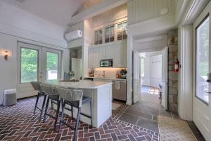 a kitchen with a counter and chairs in it at Pool Cottage at Roundtop Estate couples oasis in Wrightsville