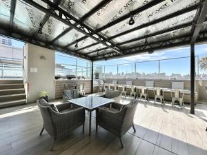 a patio with a table and chairs on a balcony at Modern and Warm Apartment in Buenos Aires