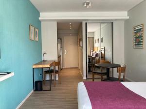 a room with a bed and a table and a kitchen at Modern and Warm Apartment in Buenos Aires