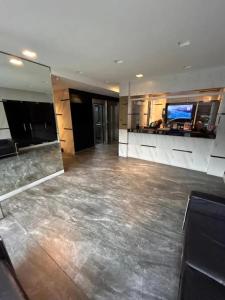 a large empty room with a television in a building at Modern and Warm Apartment in Buenos Aires