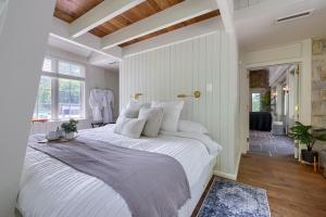 a bedroom with a large white bed with white pillows at Pool Cottage at Roundtop Estate couples oasis in Wrightsville +25 photos