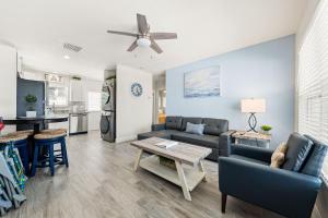a living room with a couch and a table at Sun and Sea By Beachside Management in Siesta Key
