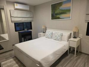a bedroom with a large white bed and a window at 2 Bedroom Apartment in Naiyang - The Title Residences, Naiyang in Nai Yang Beach +25 photos