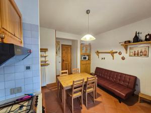 a living room with a table and a couch at Chalet Erminia in Castel di Sangro