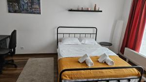 a bedroom with a bed with two pillows on it at Luca Apartament in Bucharest