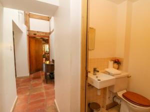 a bathroom with a toilet and a sink at Gaer Hall in Guilsfield +36 photos