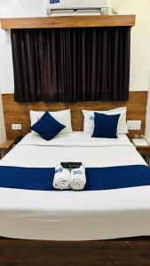 a bedroom with a bed with two towels on it at Hotel BG Inn in Bengaluru