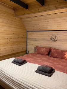 a bedroom with a bed with two pillows on it at Vikendica A&J in Blidinje