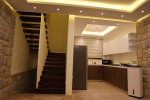 a staircase leading up to a kitchen with a stair case at Moonvalley in ‘Ayn Qanīyah