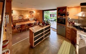 a kitchen with a table and a dining room at Superbe Maison Avec Piscine in Mombrier