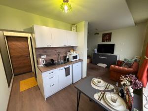 a small kitchen and living room with a table at Yantra Tower Deluxe in Gabrovo