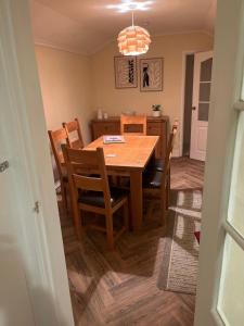 a dining room with a wooden table and chairs at King Edward house in Rhymney