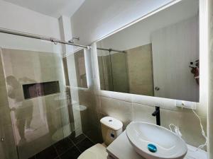 a bathroom with a sink and a shower and a toilet at Penthouse Duplex Apartment en Cali, Ciudad 2000 in Cali +23 photos