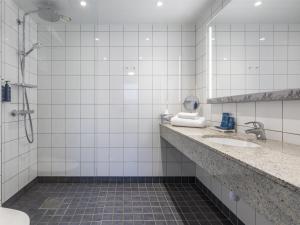 a bathroom with two sinks and a shower at Radisson Blu Hotel Uppsala in Uppsala