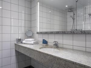 a bathroom with a sink and a mirror at Radisson Blu Hotel Uppsala in Uppsala