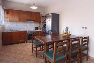 a kitchen with a table and chairs and a refrigerator at Villa Nestor in Platamonas