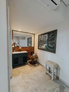 ein Badezimmer mit einem Waschbecken, einem Stuhl und einem Spiegel in der Unterkunft Suites Lassa in Ensenada