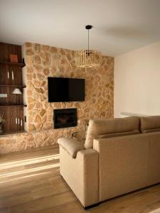 a living room with a couch and a fireplace at La villa de Ramona in Argamasilla de Alba