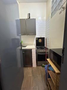 a small kitchen with a stove and a counter at Charmant Studio front de terre Dakar in Dakar +7 photos