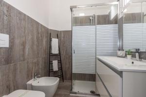 a bathroom with a toilet and a sink and a shower at Hotel apartments Crisvan in Bellaria-Igea Marina +74 photos