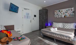 a living room with a bed and a couch at Hotel apartments Crisvan in Bellaria-Igea Marina