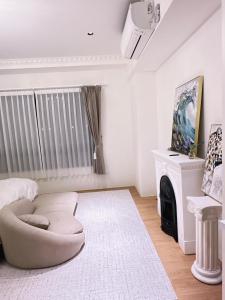 a living room with a white couch and a fireplace at 莉莉安の家 6-13人包棟 in Wujie +8 photos