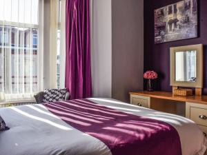 Ένα ή περισσότερα κρεβάτια σε δωμάτιο στο The Sandcastle