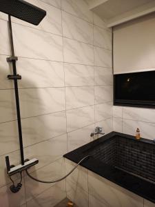 a room with a tv on a wall at 莉莉安の家 6-13人包棟 in Wujie