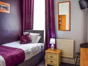 Ένα ή περισσότερα κρεβάτια σε δωμάτιο στο The Sandcastle