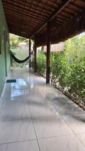 a patio with a hammock in a house at Casa Lari milagres in São Miguel dos Milagres