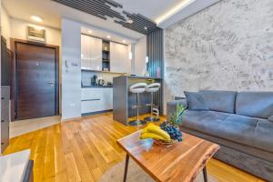 a living room with a couch and a table at Jazz apartman Titova vila in Zlatibor