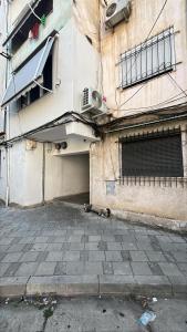a building with a gate on the side of it at Itan’s apartments in Tirana