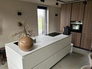a kitchen with a counter with a vase on it at B&B Smalle Ee Kleasterpleats 
