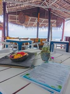 a bowl of fruit sitting on top of a table at Why Not Guest house - Hikkaduwa in Hikkaduwa