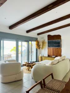a living room with two white couches and a table at Villa Aristoteles in Líndos