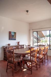 a dining room with a wooden table and chairs at Casa del Rey in Taxco de Alarcón +13 photos