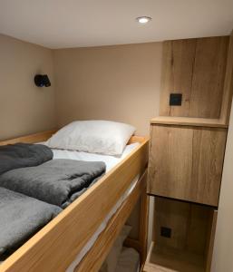 a bedroom with two beds and wooden cabinets at Le 1954 La Rosière in La Rosière