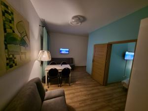 a living room with a table and chairs and a couch at Hotel Sarai Wrocław in Wrocław