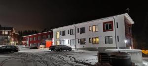 a building with a car parked in the snow at night at Levillenet SkiStar Superior Studios in Levi