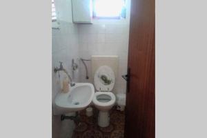 a small bathroom with a toilet and a sink at Guest house Perfect Location in Bol