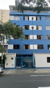 a blue building on the side of a street at Hostal Winya in Lima