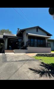 a large house with a porch and a driveway at Crump's Loft House in Durban