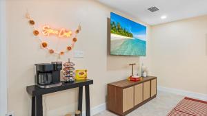 a room with a table with a coffee maker on it at The Shark Tank Cocoa Beach - Retro Florida, Downtown, 5-Min Walk to Beach, Shops & Bars in Cocoa Beach