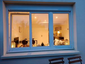 a window with a view of a living room at La Terrasse de Mâlain in Mâlain +7 photos