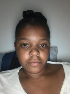 a woman sitting in a chair looking at the camera at Rejoice Thuli in Mabopane