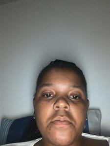 a woman sitting in a chair looking at the camera at Rejoice Thuli in Mabopane