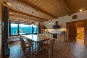 a kitchen and dining room with a table and chairs at Шале 5 Стефанія in Mykulychyn